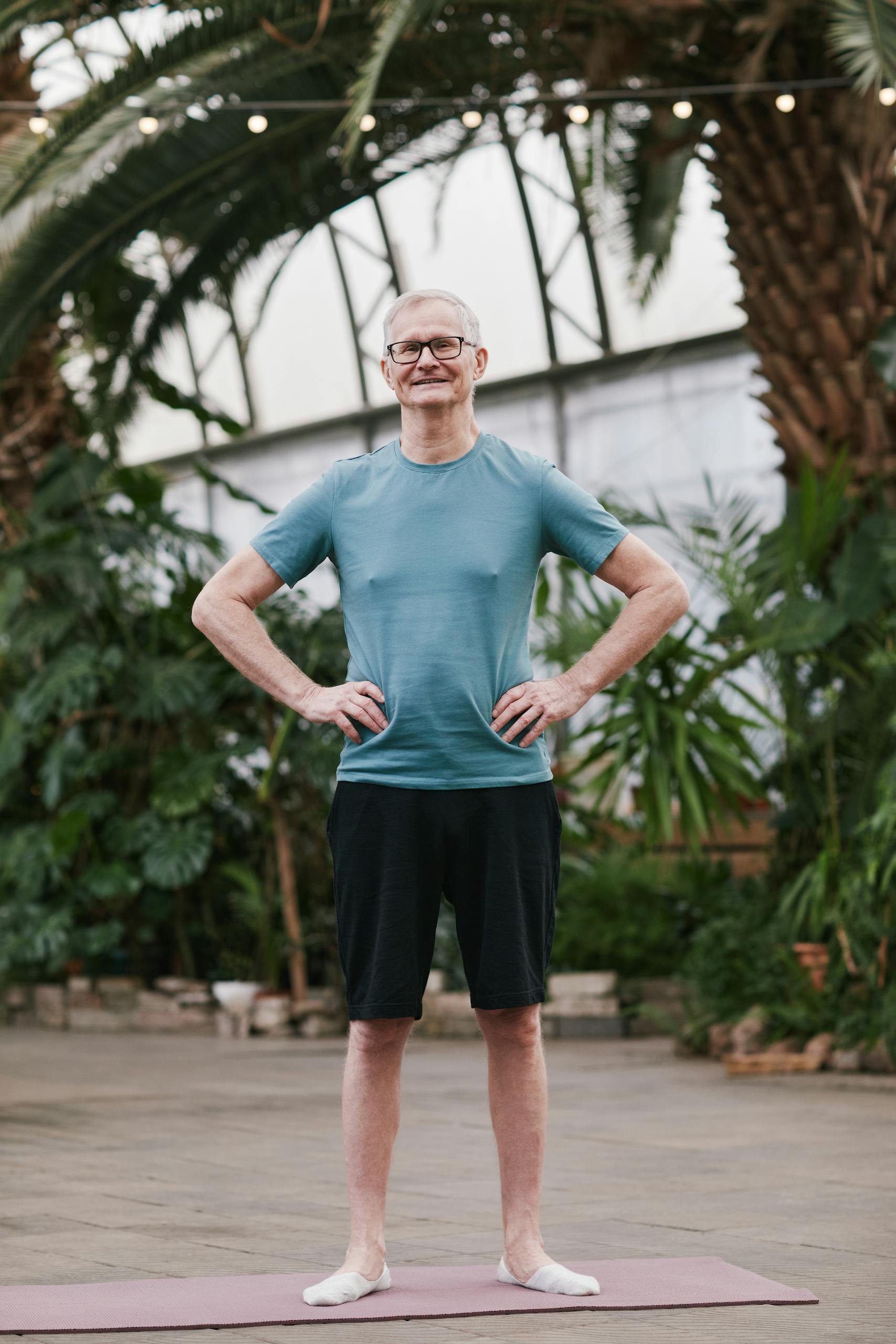 Elderly man enjoying a workout in a lush tropical environment, emphasizing healthy lifestyle.